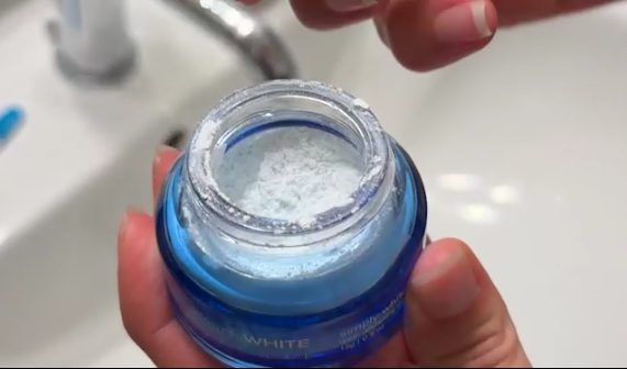 Open jar of PurelyWHITE Deluxe showing the whitening powder inside